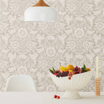 Conservatory wallpaper featuring stylized petals and leaves dervived from a block-print technique was designed by Katharine Watson for Hygge & West. Featuring white flowers on a pewter gray wallpaper background.