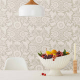 Conservatory wallpaper featuring stylized petals and leaves dervived from a block-print technique was designed by Katharine Watson for Hygge & West. Featuring white flowers on a pewter gray wallpaper background.