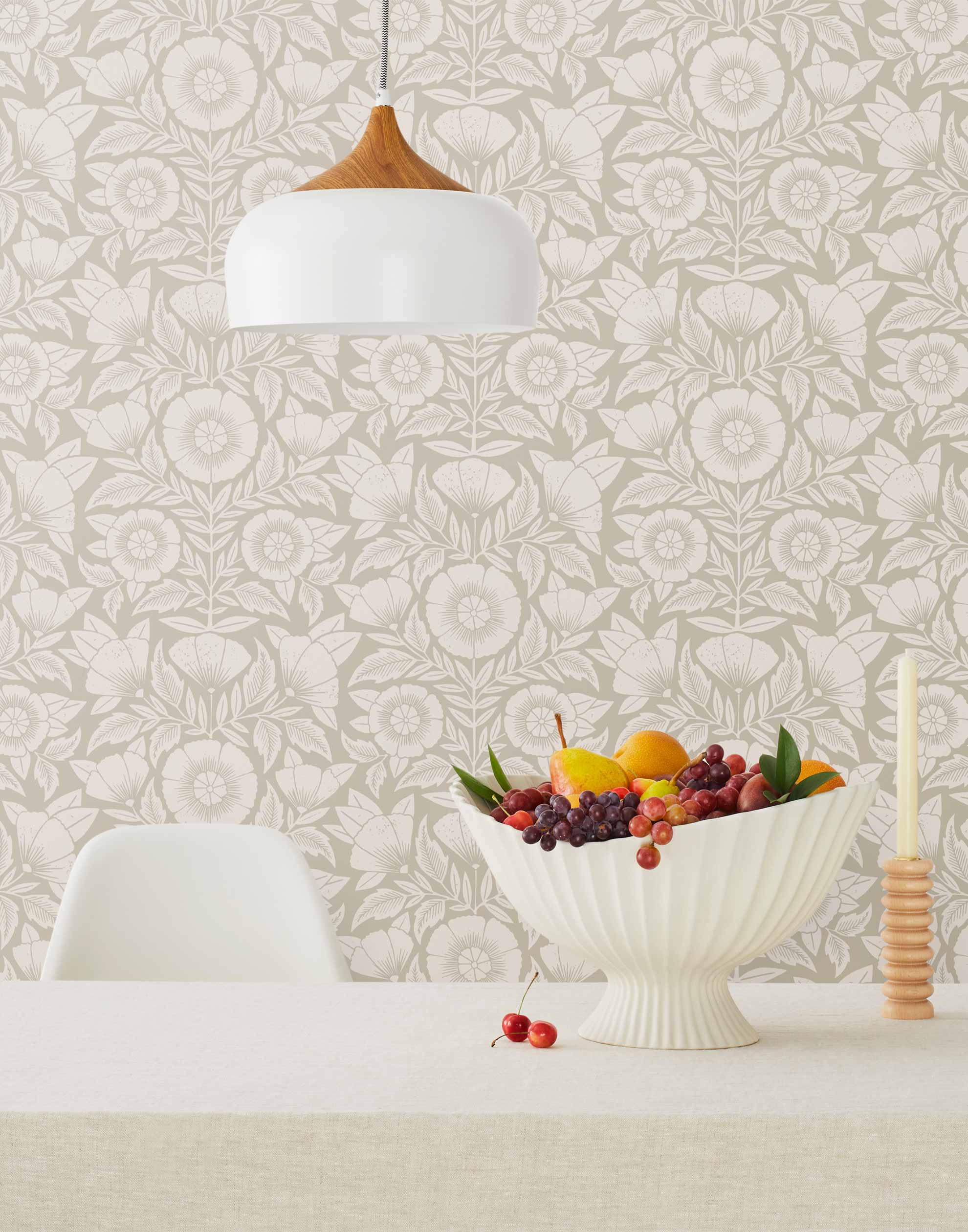 Conservatory wallpaper featuring stylized petals and leaves dervived from a block-print technique was designed by Katharine Watson for Hygge & West. Featuring white flowers on a pewter gray wallpaper background.