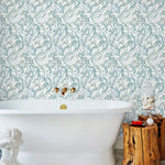 Atoll (Marine) wallpaper features shades of green and blue seaweed and coral on a true white background