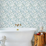 Atoll (Marine) wallpaper features shades of green and blue seaweed and coral on a true white background