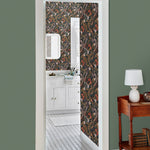 Atoll (Coral) wallpaper features shades of orange, purple, brown and green seaweed and coral on a soft black background
