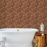 Atoll (Sienna) wallpaper features shades of green, pink, peach, taupe and black seaweed and coral on a brown background