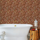 Atoll (Sienna) wallpaper features shades of green, pink, peach, taupe and black seaweed and coral on a brown background