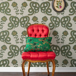 Serpentine (Juniper) Wallpaper featuring deep green and metallic gold snakes and flowers on a soft gray background