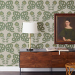 Serpentine (Juniper) Wallpaper featuring deep green and metallic gold snakes and flowers on a soft gray background