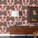 Serpentine (Punch) Wallpaper featuring black and metallic gold snakes and flowers on a punchy pink background