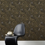 Forest Floor (Ebony) features an intricate, leafy pattern in metallic gold and gray on black