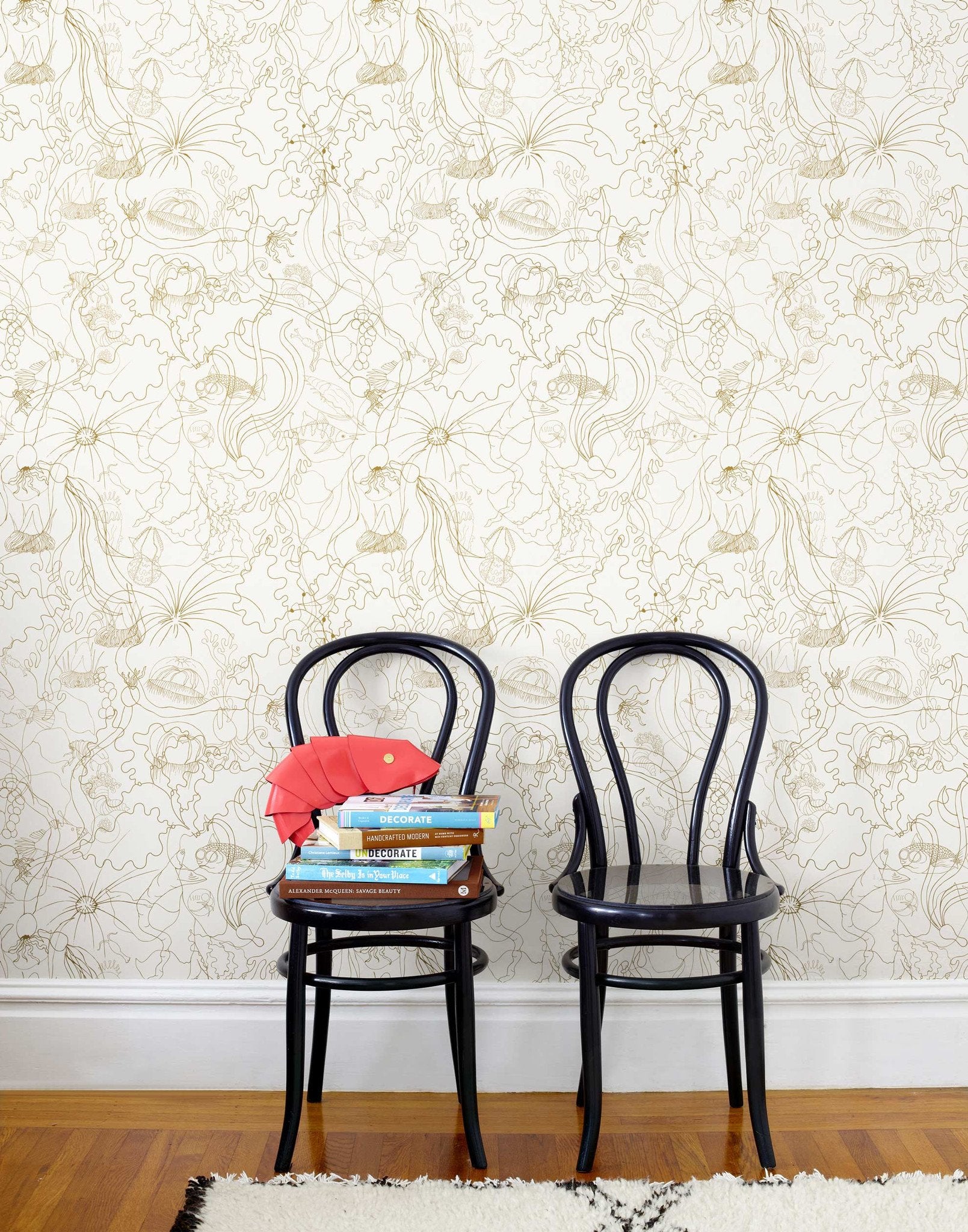 Underwater World (Gold) features a yet delicate pattern of fish and seaweed in metallic on white
