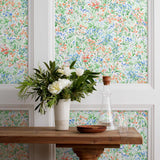 Summer (Vermillion) wallpaper features loose brushstrokes that capture the movement of wild flowers and grasses swaying in the breeze. Coral red, blue and green watercolored flora on a white background | Hygge & West