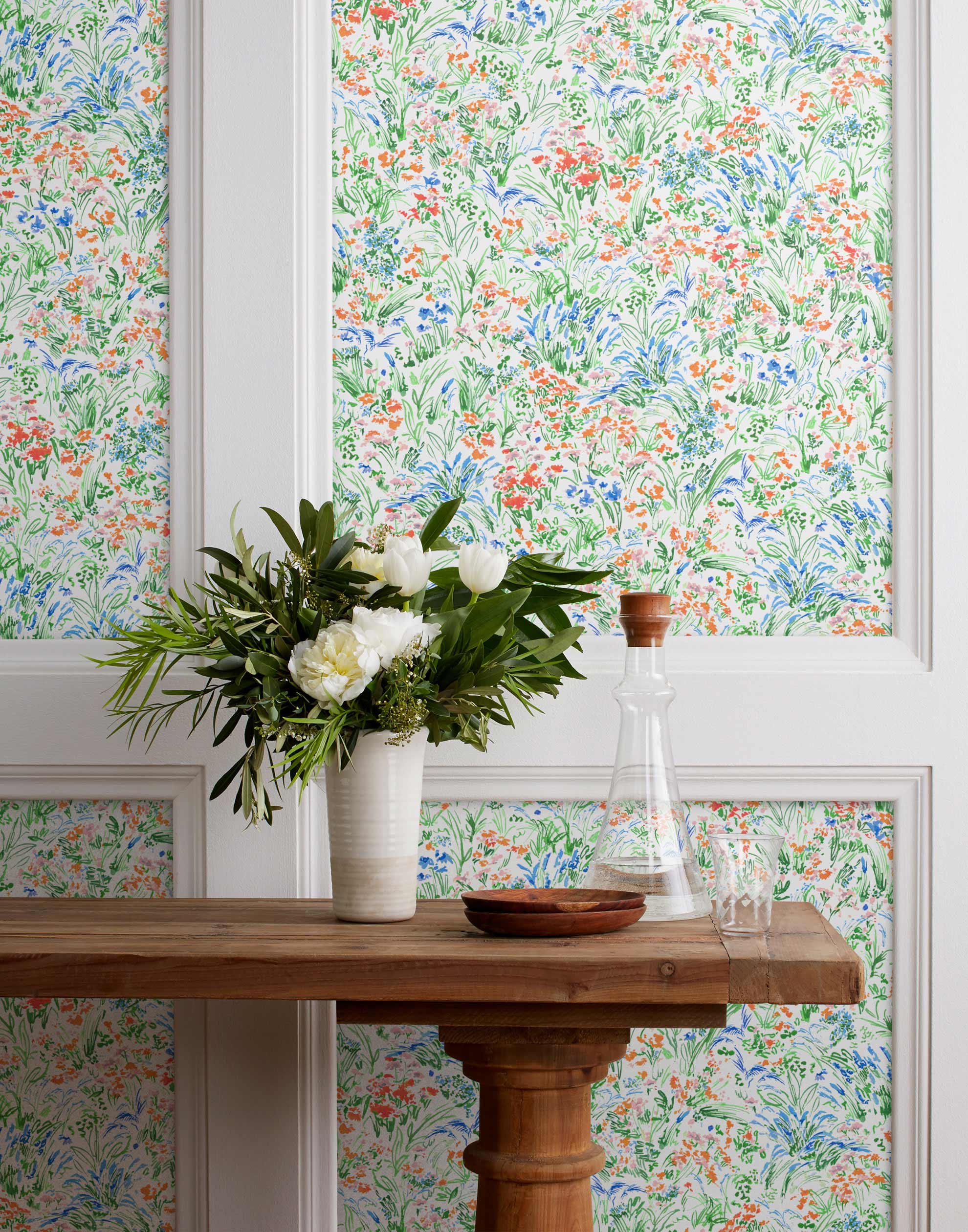 Summer (Vermillion) wallpaper features loose brushstrokes that capture the movement of wild flowers and grasses swaying in the breeze. Coral red, blue and green watercolored flora on a white background | Hygge & West