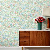 Summer (Vermillion) wallpaper features loose brushstrokes that capture the movement of wild flowers and grasses swaying in the breeze. Coral red, blue and green watercolored flora on a white background | Hygge & West