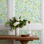 Summer (Sunshine) wallpaper features loose brushstrokes that capture the movement of wild flowers and grasses swaying in the breeze. Yellow, gold, light blue, and green watercolored flora on a white background | Hygge & West