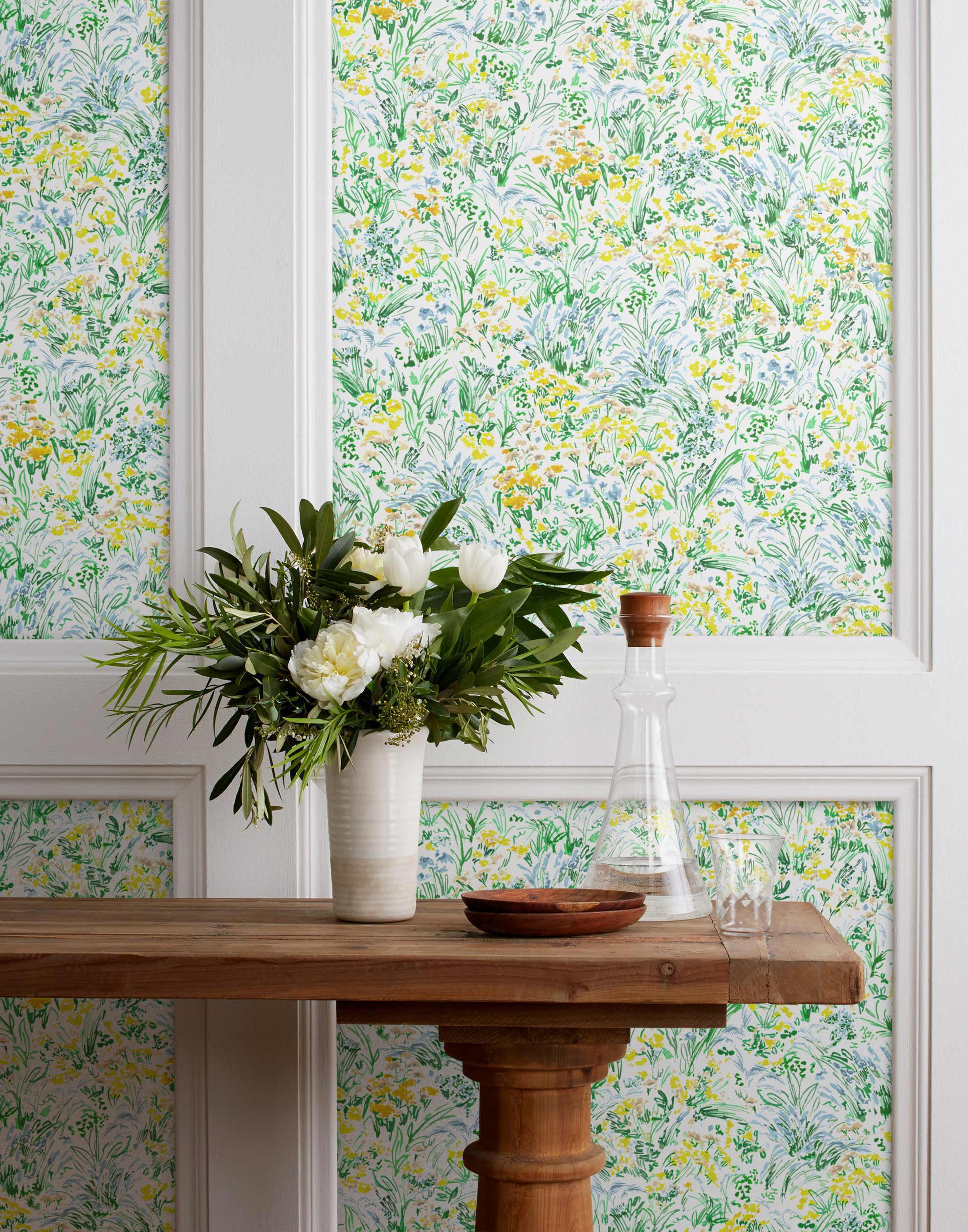 Summer (Sunshine) wallpaper features loose brushstrokes that capture the movement of wild flowers and grasses swaying in the breeze. Yellow, gold, light blue, and green watercolored flora on a white background | Hygge & West
