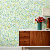 Summer (Sunshine) wallpaper features loose brushstrokes that capture the movement of wild flowers and grasses swaying in the breeze. Yellow, gold, light blue, and green watercolored flora on a white background | Hygge & West