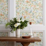 Summer (Bluebell) wallpaper features loose brushstrokes that capture the movement of wild flowers and grasses swaying in the breeze. Orange, blue, purple, and green watercolored flora on a white background | Hygge & West