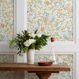 Summer (Bluebell) wallpaper features loose brushstrokes that capture the movement of wild flowers and grasses swaying in the breeze. Orange, blue, purple, and green watercolored flora on a white background | Hygge & West