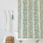Amity Sunset (Sky) Shower Curtain with dusty blue, orange, and cream illustrations depicts scenes from the iconic movie Jaws and was created in collaboration with Universal | Hygge & West