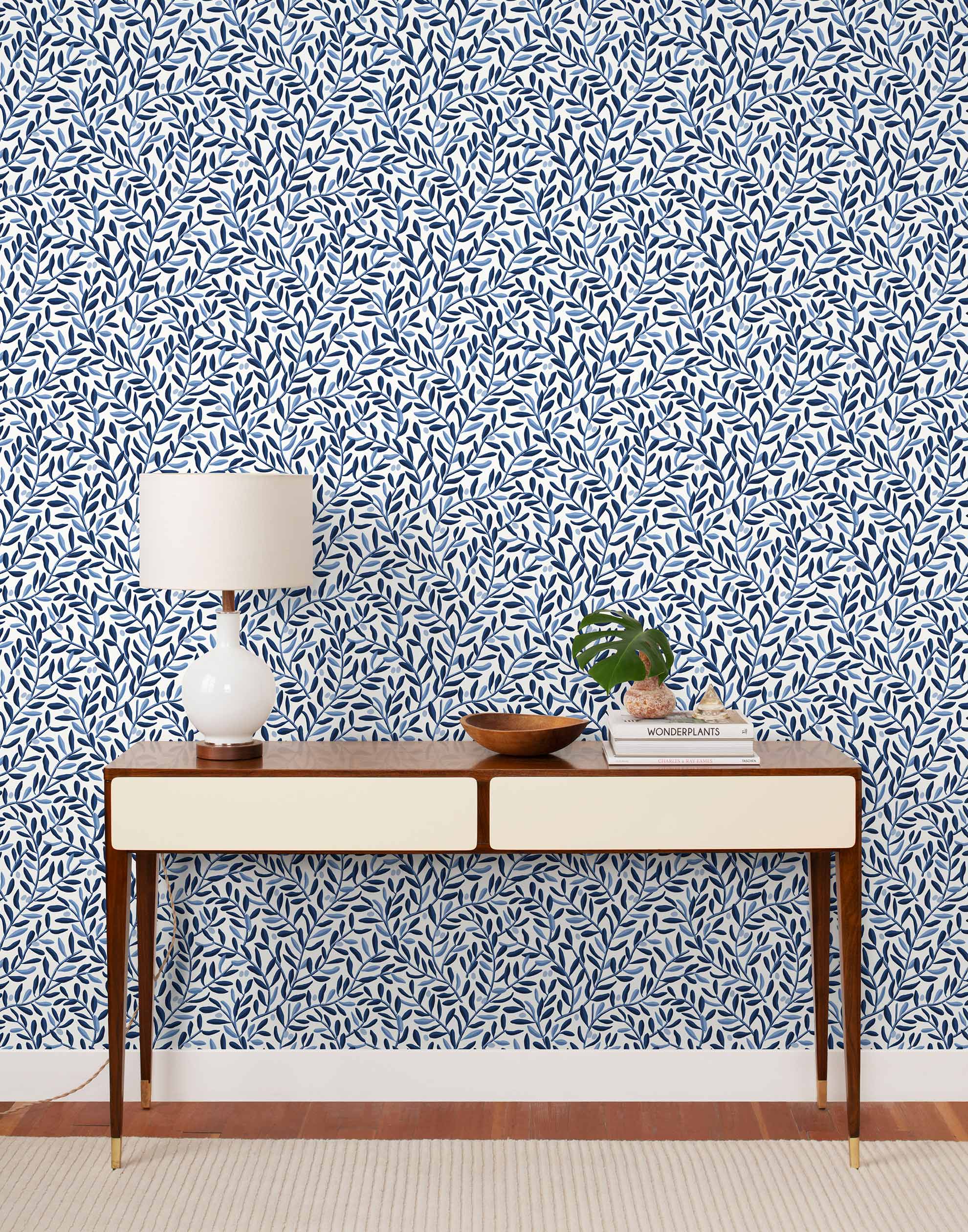 Olive Grove (Blue) featuring a leafy vine motif in shades of blue with light blue accents on a true white background | Schoolhouse x Hygge & West Wallpaper Collection