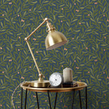 Olive Grove (Midnight) featuring a leafy vine motif in shades of green with metallic copper accents on a deep blue background | Schoolhouse x Hygge & West Wallpaper Collection