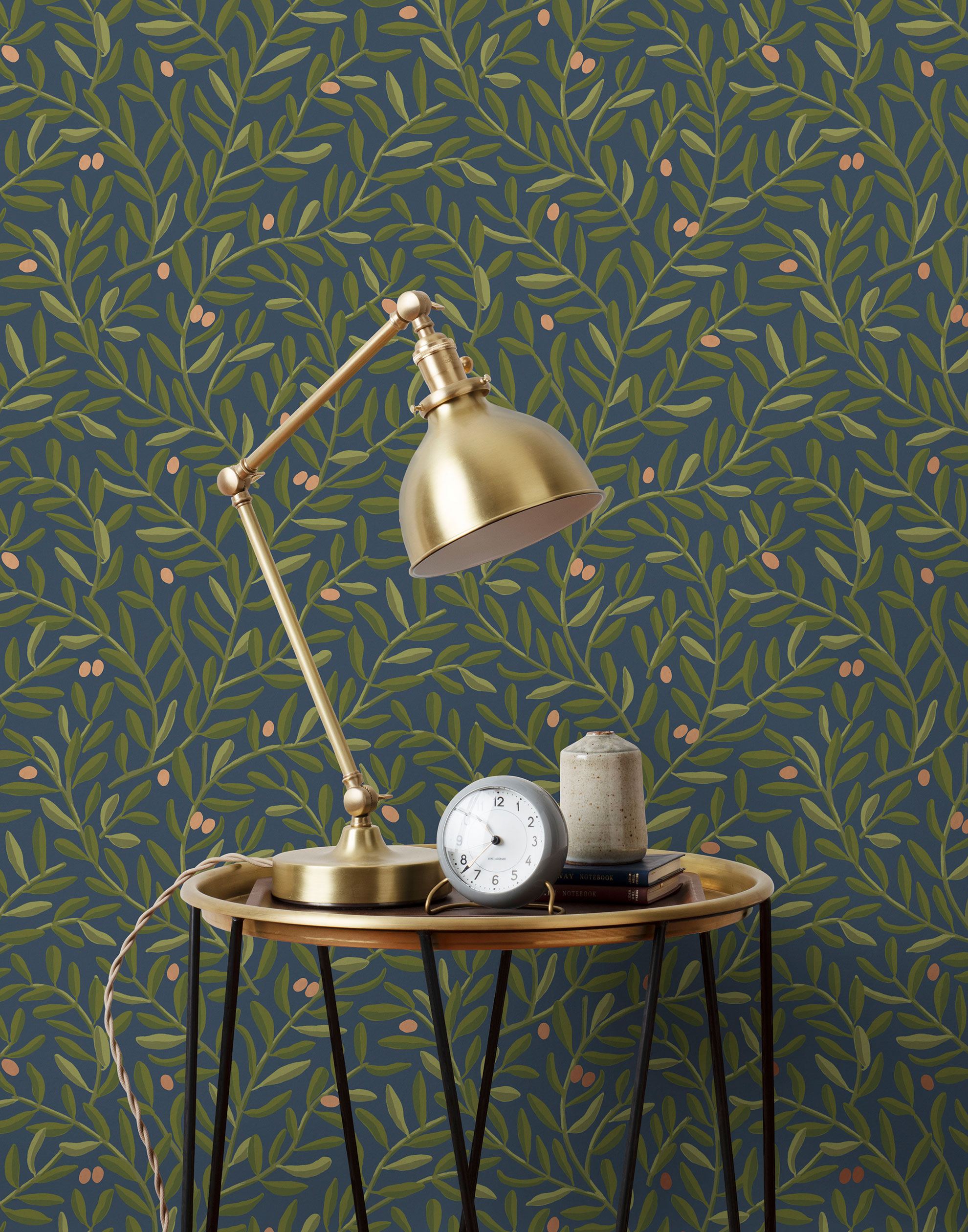 Olive Grove (Midnight) featuring a leafy vine motif in shades of green with metallic copper accents on a deep blue background | Schoolhouse x Hygge & West Wallpaper Collection