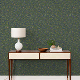 Olive Grove (Midnight) featuring a leafy vine motif in shades of green with metallic copper accents on a deep blue background | Schoolhouse x Hygge & West Wallpaper Collection