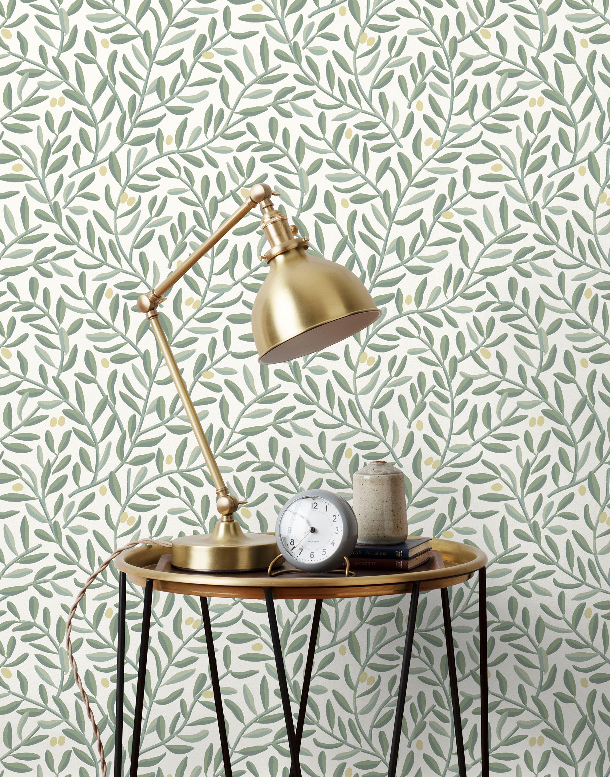 Olive Grove (Spruce) featuring a leafy vine motif in shades of green with pale yellow accents on an off white background | Schoolhouse x Hygge & West Wallpaper Collection