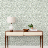 Olive Grove (Spruce) featuring a leafy vine motif in shades of green with pale yellow accents on an off white background | Schoolhouse x Hygge & West Wallpaper Collection