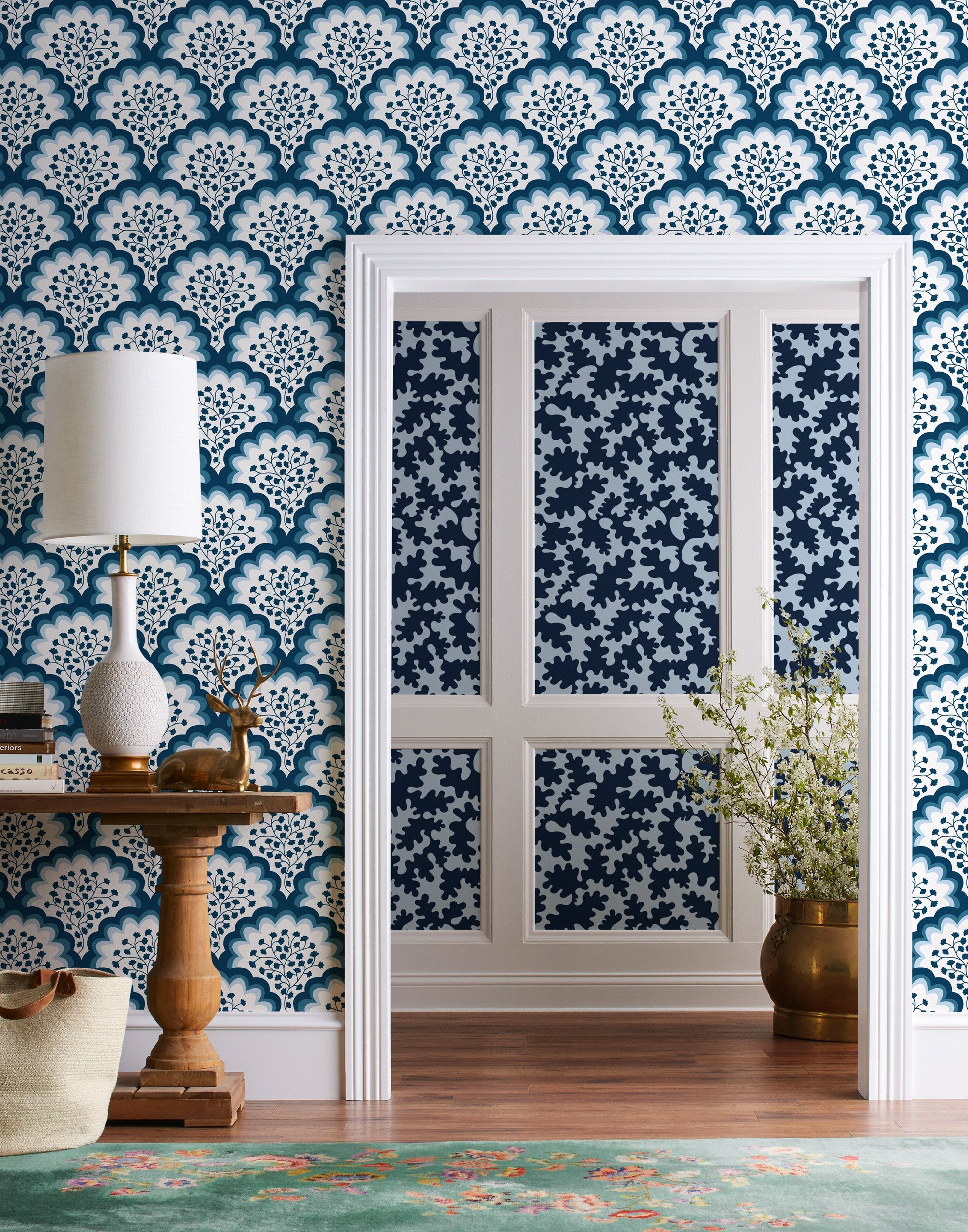 Angelina (Navy) wallpaper features a White background with graduated blue scallops and navy floral motif