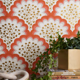 Angelina (Coral) wallpaper features an Off white background with graduated coral scallops and gold floral motif
