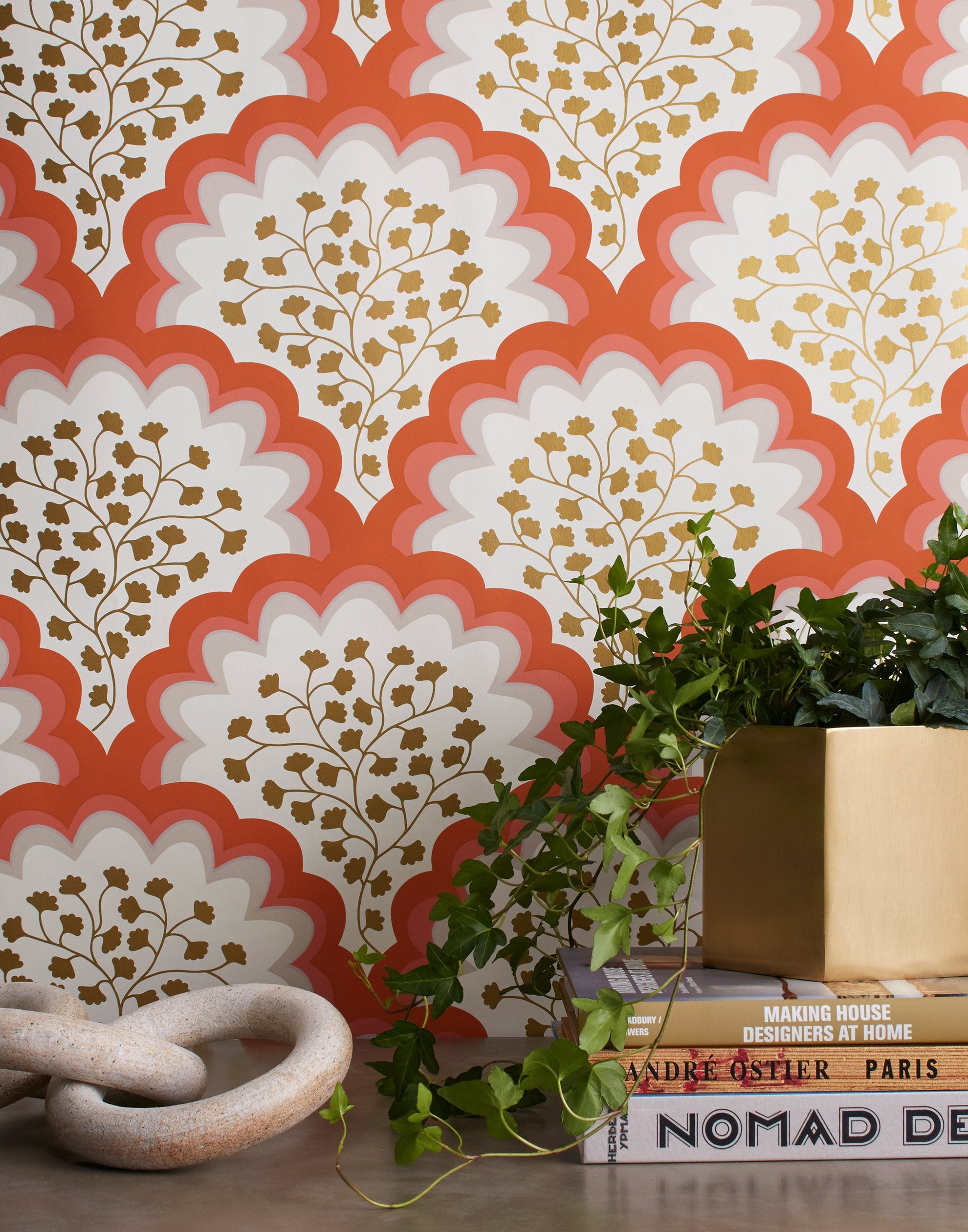 Angelina (Coral) wallpaper features an Off white background with graduated coral scallops and gold floral motif