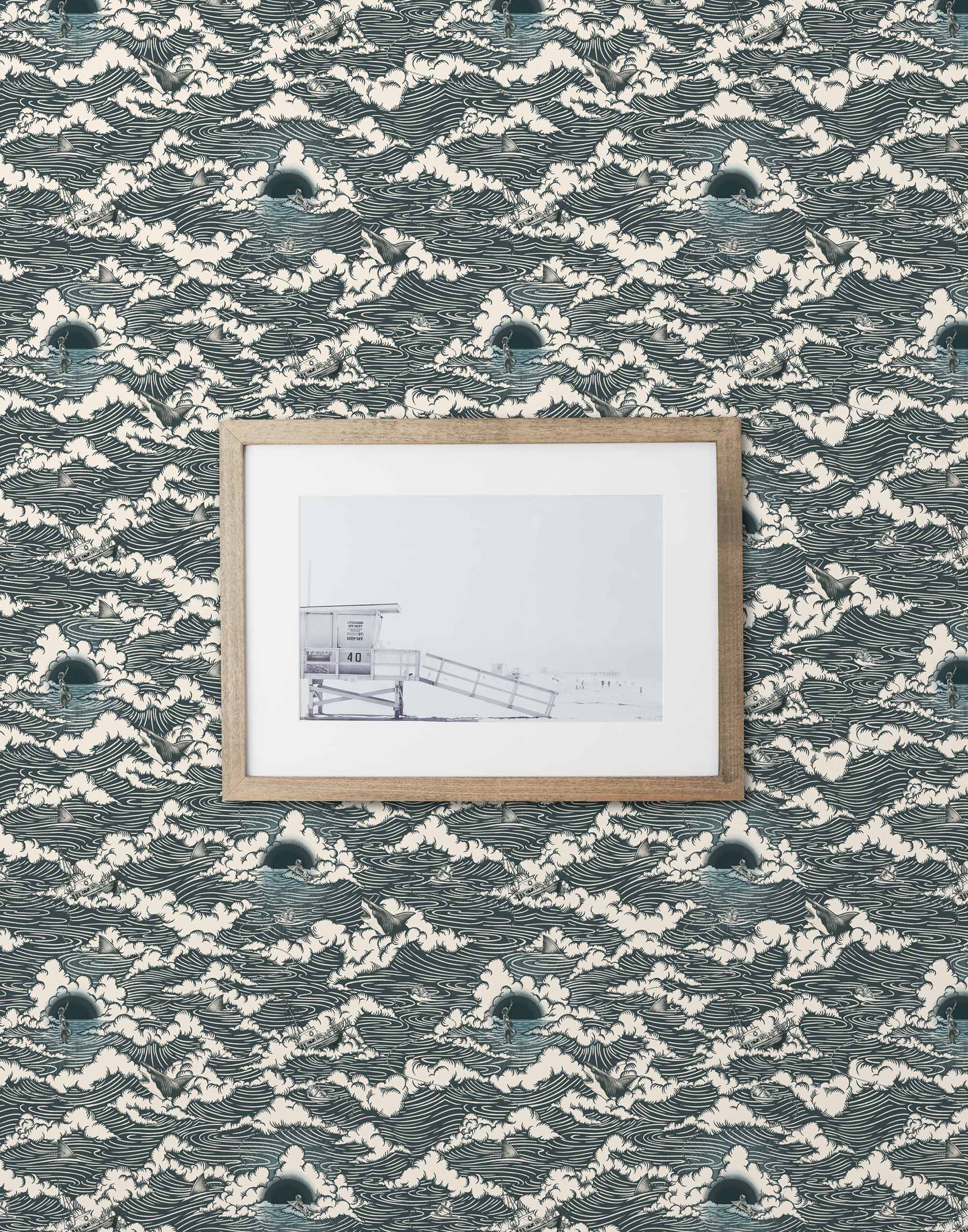 Amity Sunset (Ink) Wallpaper with dark blue and off white illustrations depicts scenes from the iconic movie Jaws and was created in collaboration with Universal | Hygge & West