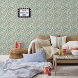 Amity Sunset (Sky) Wallpaper with dusty blue, cream and orange illustrations depicts scenes from the iconic movie Jaws and was created in collaboration with Universal | Hygge & West