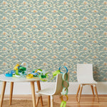 Amity Sunset (Sky) Wallpaper with dusty blue, cream and orange illustrations depicts scenes from the iconic movie Jaws and was created in collaboration with Universal | Hygge & West