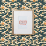 Amity Sunset (Indigo) Wallpaper with navy blue, white, and orange illustrations depicts scenes from the iconic movie Jaws and was created in collaboration with Universal | Hygge & West