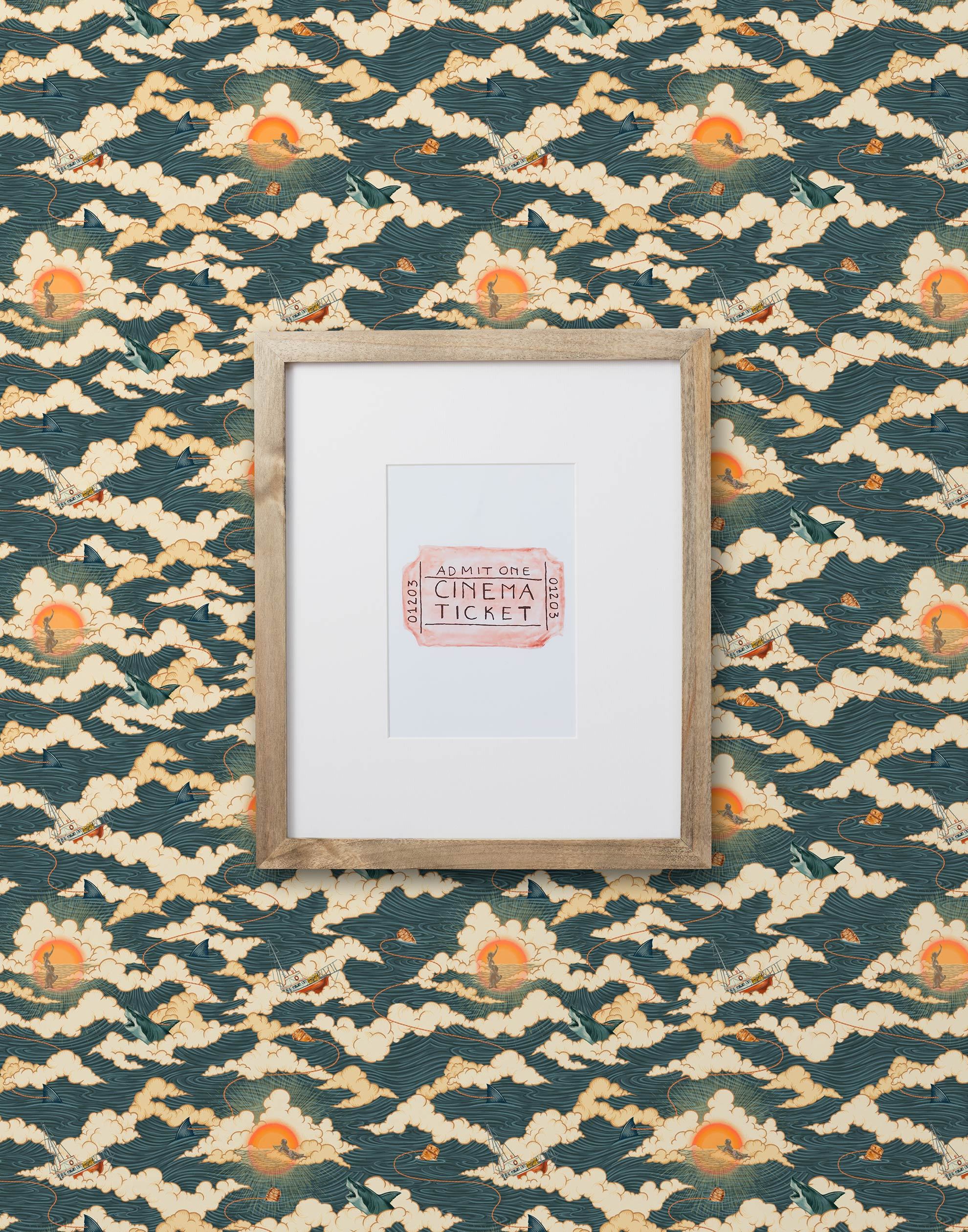 Amity Sunset (Indigo) Wallpaper with navy blue, white, and orange illustrations depicts scenes from the iconic movie Jaws and was created in collaboration with Universal | Hygge & West