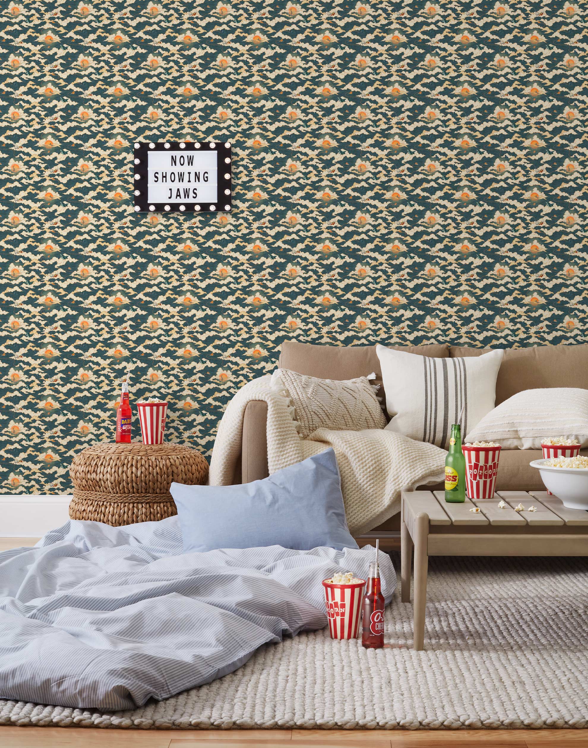 Amity Sunset (Indigo) Wallpaper with navy blue, white, and orange illustrations depicts scenes from the iconic movie Jaws and was created in collaboration with Universal | Hygge & West