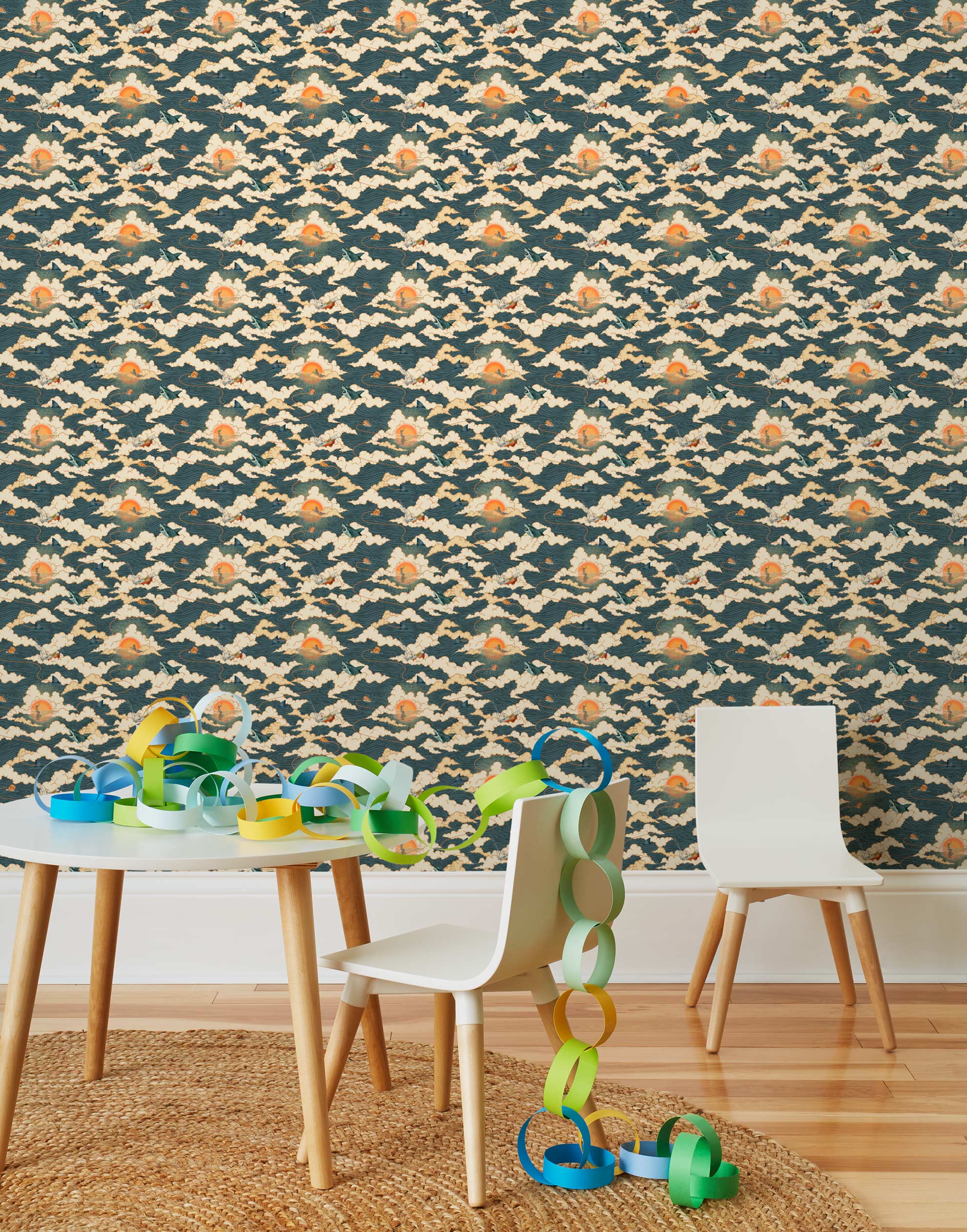 Amity Sunset (Indigo) Wallpaper with navy blue, white, and orange illustrations depicts scenes from the iconic movie Jaws and was created in collaboration with Universal | Hygge & West