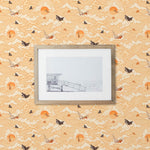 Amity Sunset (Blush) Wallpaper with pink, orange, and white illustrations depicts scenes from the iconic movie Jaws and was created in collaboration with Universal | Hygge & West