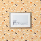 Amity Sunset (Blush) Wallpaper with pink, orange, and white illustrations depicts scenes from the iconic movie Jaws and was created in collaboration with Universal | Hygge & West