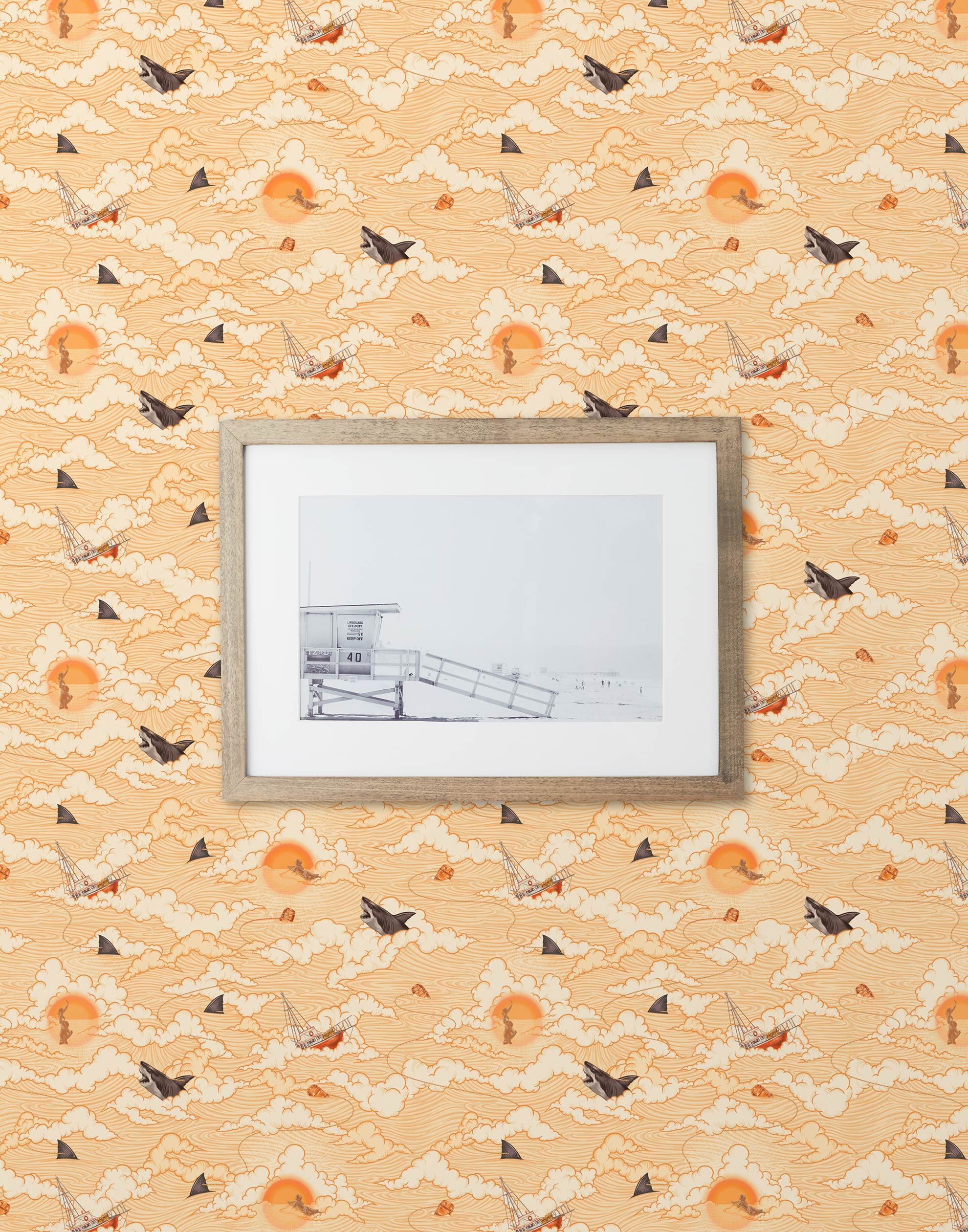 Amity Sunset (Blush) Wallpaper with pink, orange, and white illustrations depicts scenes from the iconic movie Jaws and was created in collaboration with Universal | Hygge & West