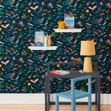 Space Owl (Midnight) wallpaper features wildlife, fauna and a flowing river | deep blue wallpaper with orange, white, brown, yellow, and green illustrations | designed by Vikki Chu