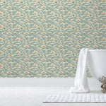 Amity Sunset (Sky) Wallpaper with dusty blue, cream and orange illustrations depicts scenes from the iconic movie Jaws and was created in collaboration with Universal | Hygge & West