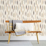 Plumes Natural Wallpaper features delicate feathers in orange, rust, blues and browns on a cream background