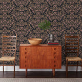 Symmetry wallpaper is a stylized floral wallpaper and designed in linocut style by Katharine Watson for Hygge & West | Metallic gold and pink flowers on a soft black wallpaper background.